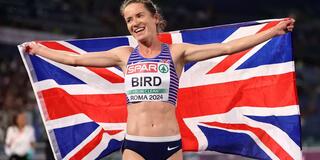 Lizzie Bird holding the United Kingdom flag