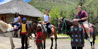 Three USF students posing on horses.