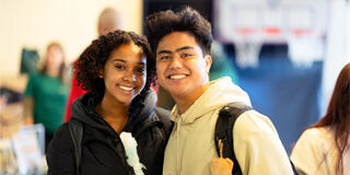 Two students smiling.