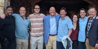 Group of people standing in a row with Chris Ehrlich in the middle