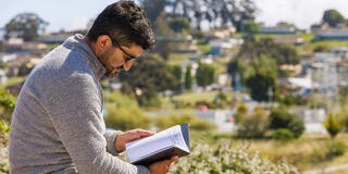 students looks down at notebook in San Francisco's Bayview neighborhood