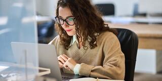 Student watching webinar on laptop