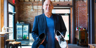 David Batstone holds a pair of shoes