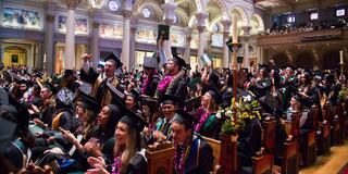 Students tossing their caps in St. Ignatius