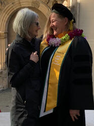 Deirdre Martinez in her cap and gown with another person