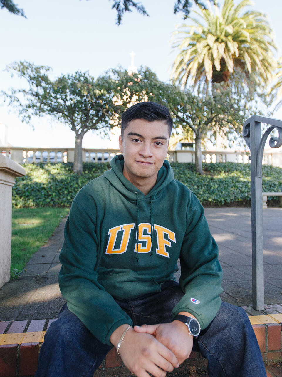 Ryan Lopez sitting on bench outside