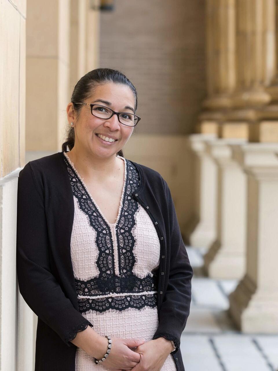 Sonya Arriola stands in front of church and poses for picture