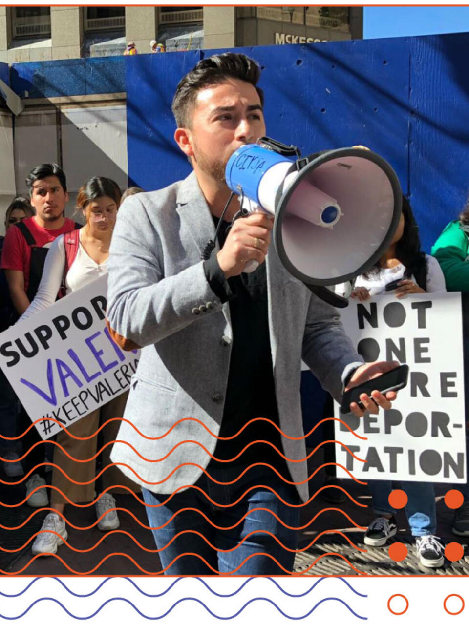 Edwin Carmona-Cruz speaking into a megaphone at a rally