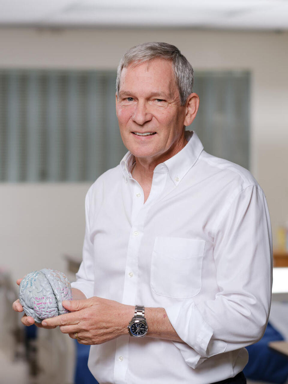 William Bosl holding a brain model